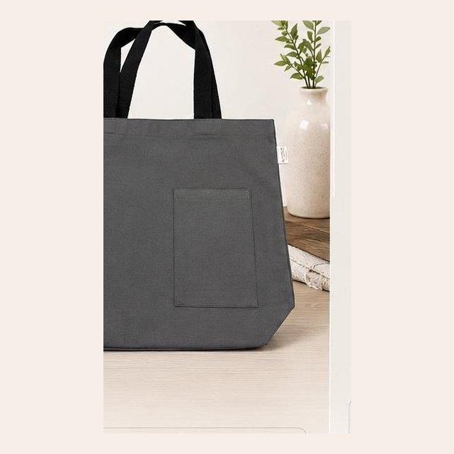 Grey canvas tote with front pocket and black handles